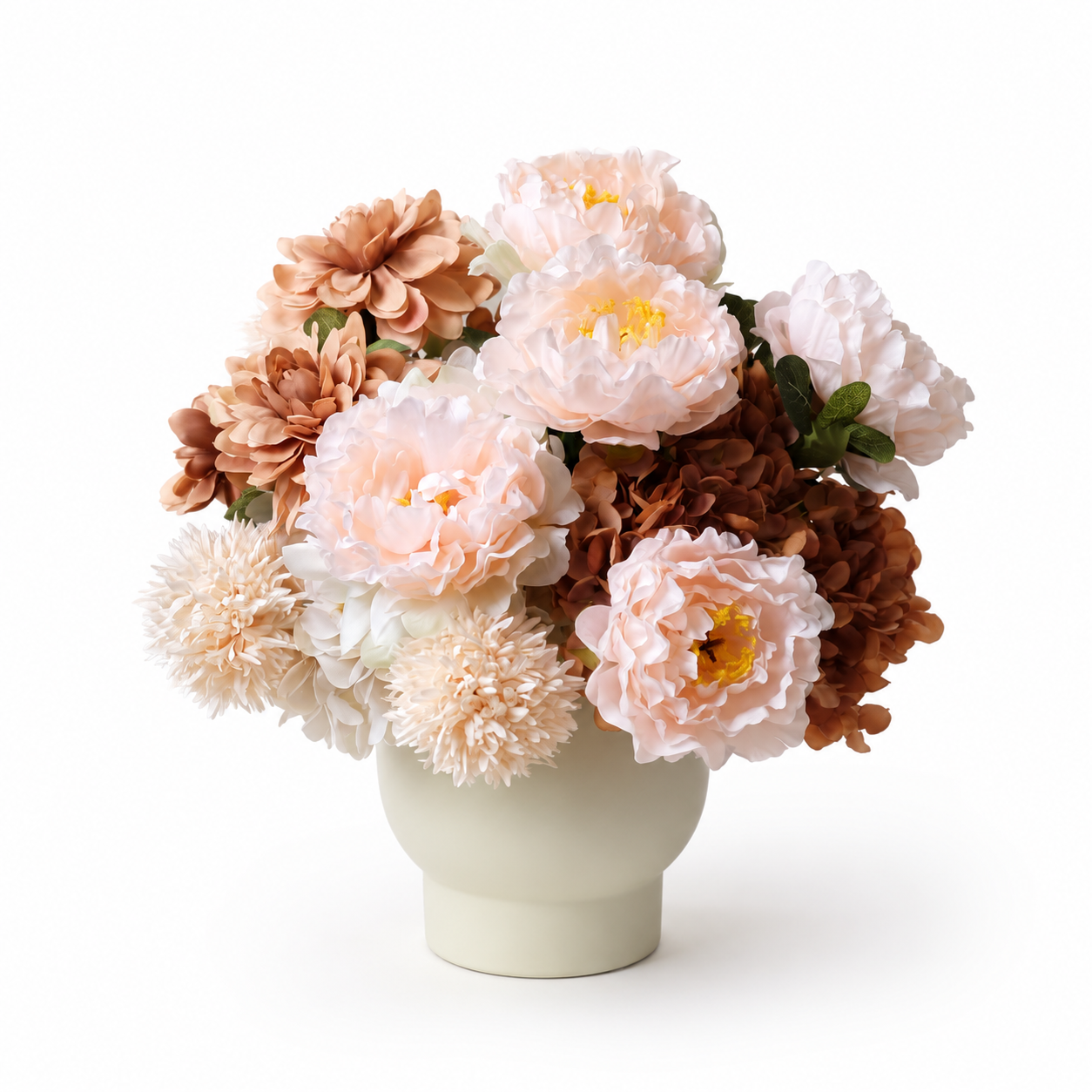 Soft peach artificial flower arrangement in a cream vase
