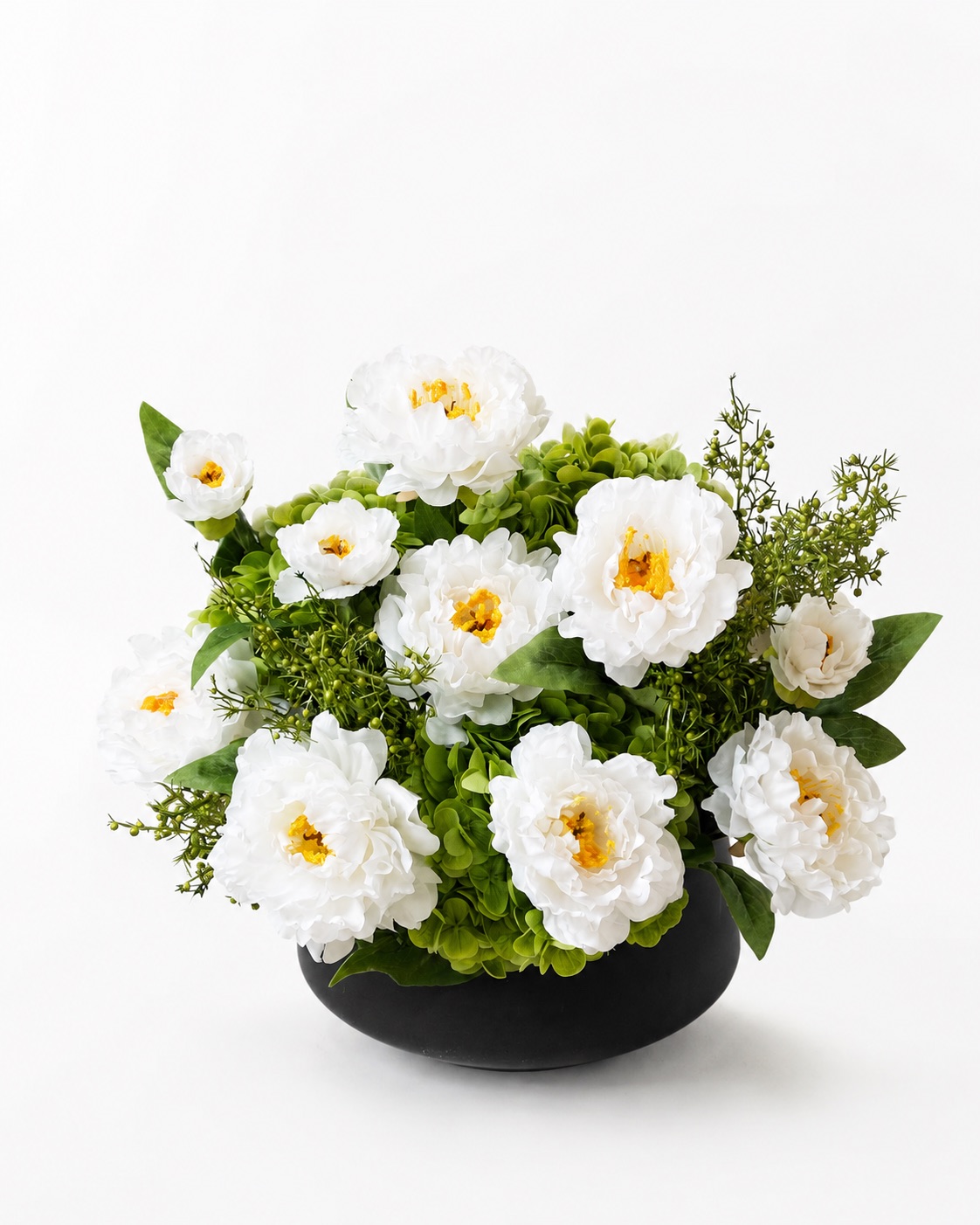 White artificial daisy flower arrangement in a black vase