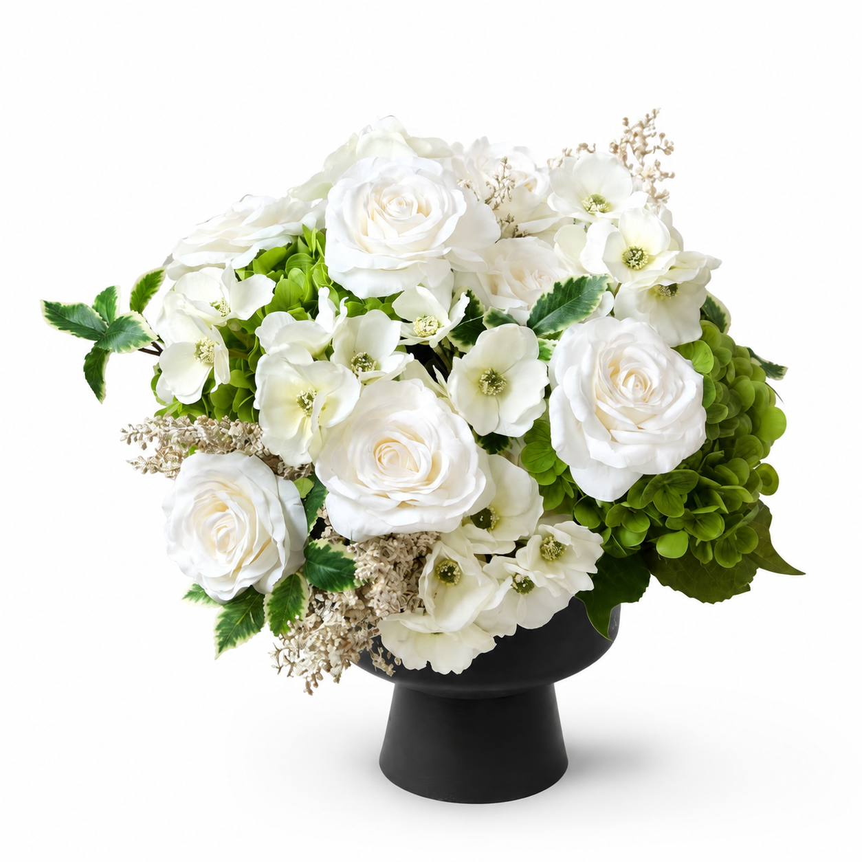 White and green artificial flower arrangement in a black vase