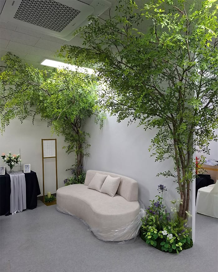 Artificial trees installed around an interior seating area