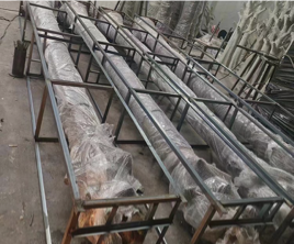 Prepared metal frames and wrapped trunks in the workshop